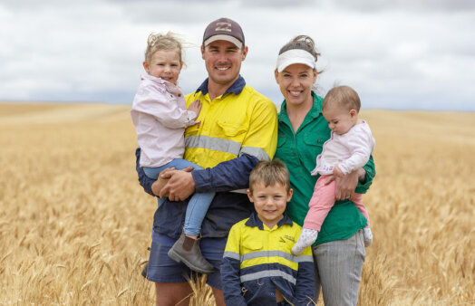 CBH family - father, mother and three children, standing in wheat field.