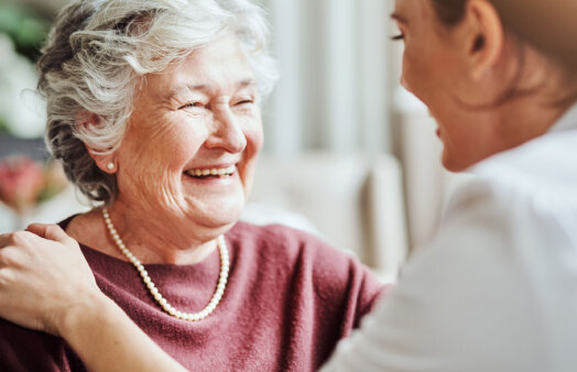 Shot of a young nurse caring for an elderly woman in a retirement home, istock