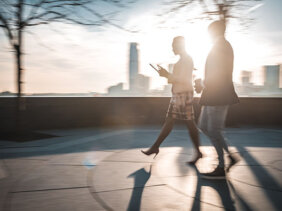 Blurred motion image of business man and woman walking in NYC