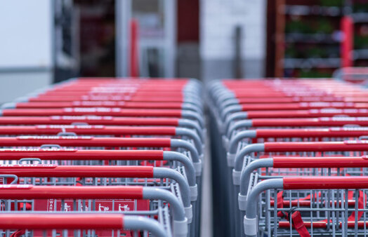 Shopping carts align together in front of a store. Photo by michal dziekonski on Unsplash