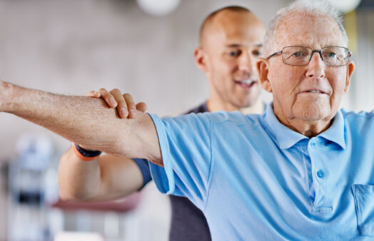 Shot of a physiotherapist helping a senior man with weights